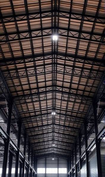 strong PVC, powerful, supporting heavy weight, photorealistic, industrial warehouse, highly detailed, metal beams and structures, load-bearing, black, overhead lighting, shot with a telephoto lens