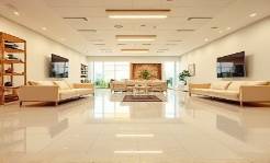 durable PVC flooring, immaculate, laying, photorealistic, spanning a spacious showroom with model furniture, highly detailed, subtle reflections, 4K quality, beige and cream tones, consistent overhead lighting, shot with an ultra-wide lens.