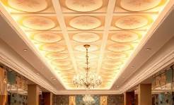 stylish PVC ceiling, modern, spanning, photorealistic, above a luxurious hotel lobby with chandeliers and art pieces, highly detailed, accentuated patterns, ultra-clear quality, warm white, ambient chandelier light, shot with a portrait lens.